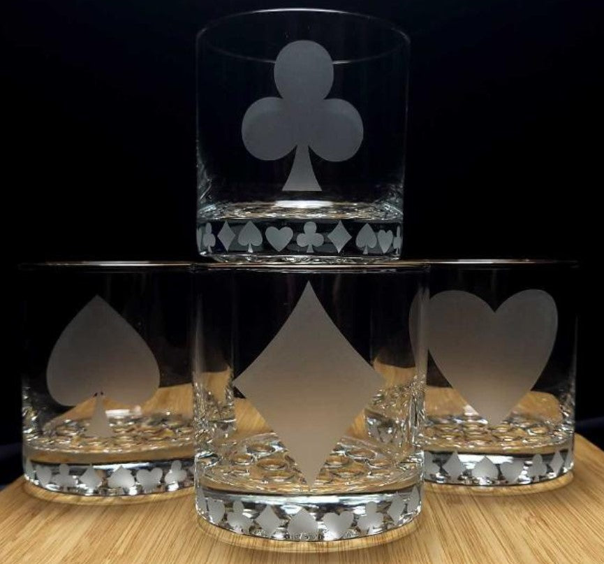 Set of card suit etched cocktail glasses featuring gambling and poker symbols, perfect for poker nights and card game enthusiasts.