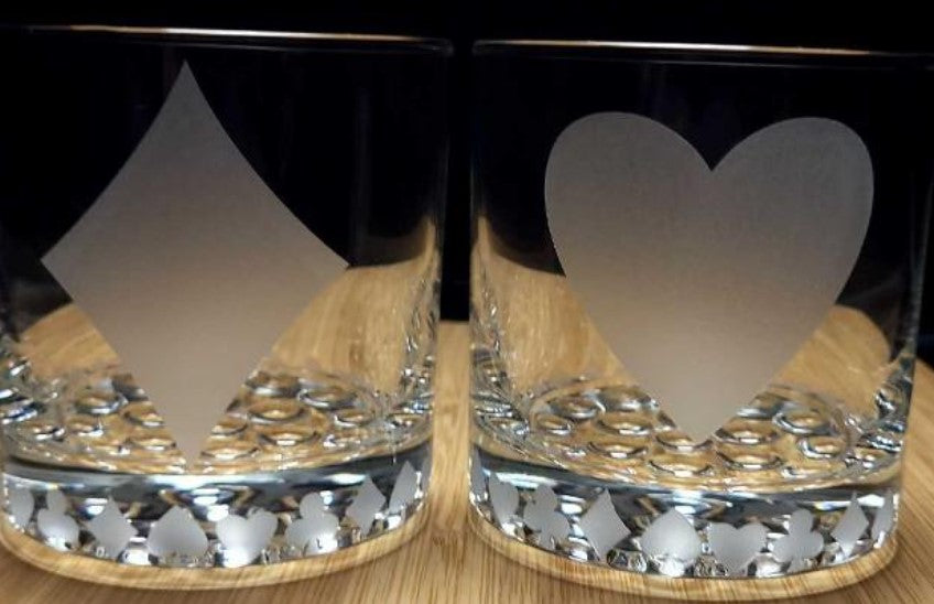 Set of cocktail glasses etched with diamond and heart card suit designs, ideal for poker enthusiasts and game night celebrations.