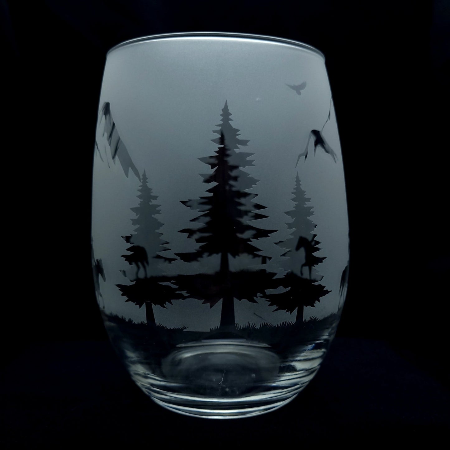 forest trees on western themed cowboys riding through the mountains