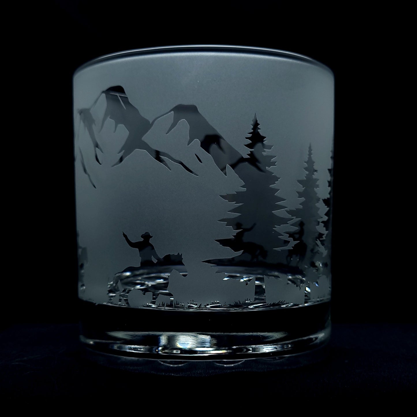 a pebbled bottom cocktail glass featuring cowboys riding through the mountains on horseback